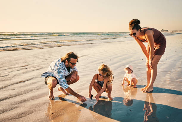 Shot of a happy young family enjoying a day at the beach