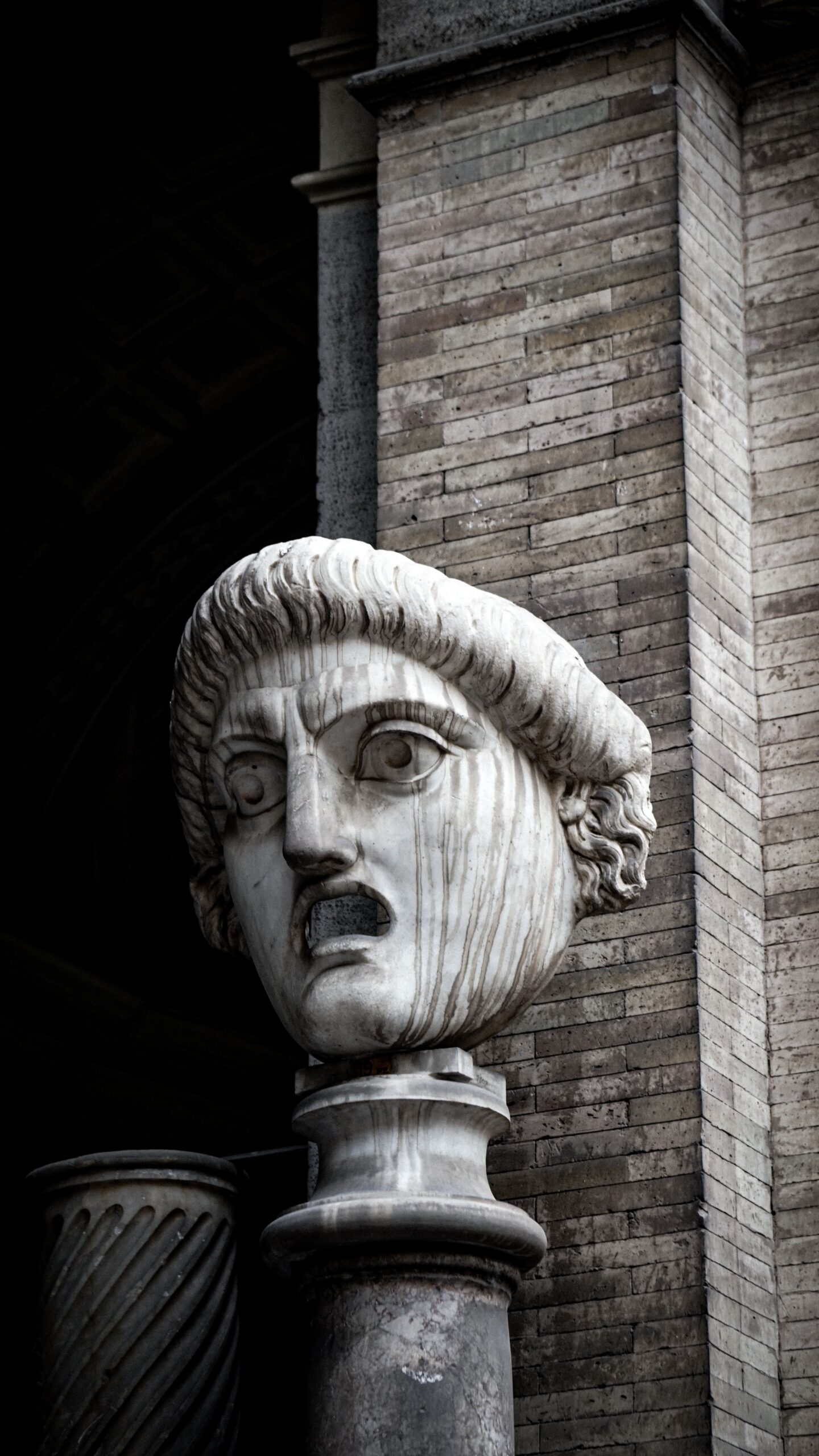 Marble sculpture of a historic Roman figure against classic architecture, evoking ancient Roman elegance