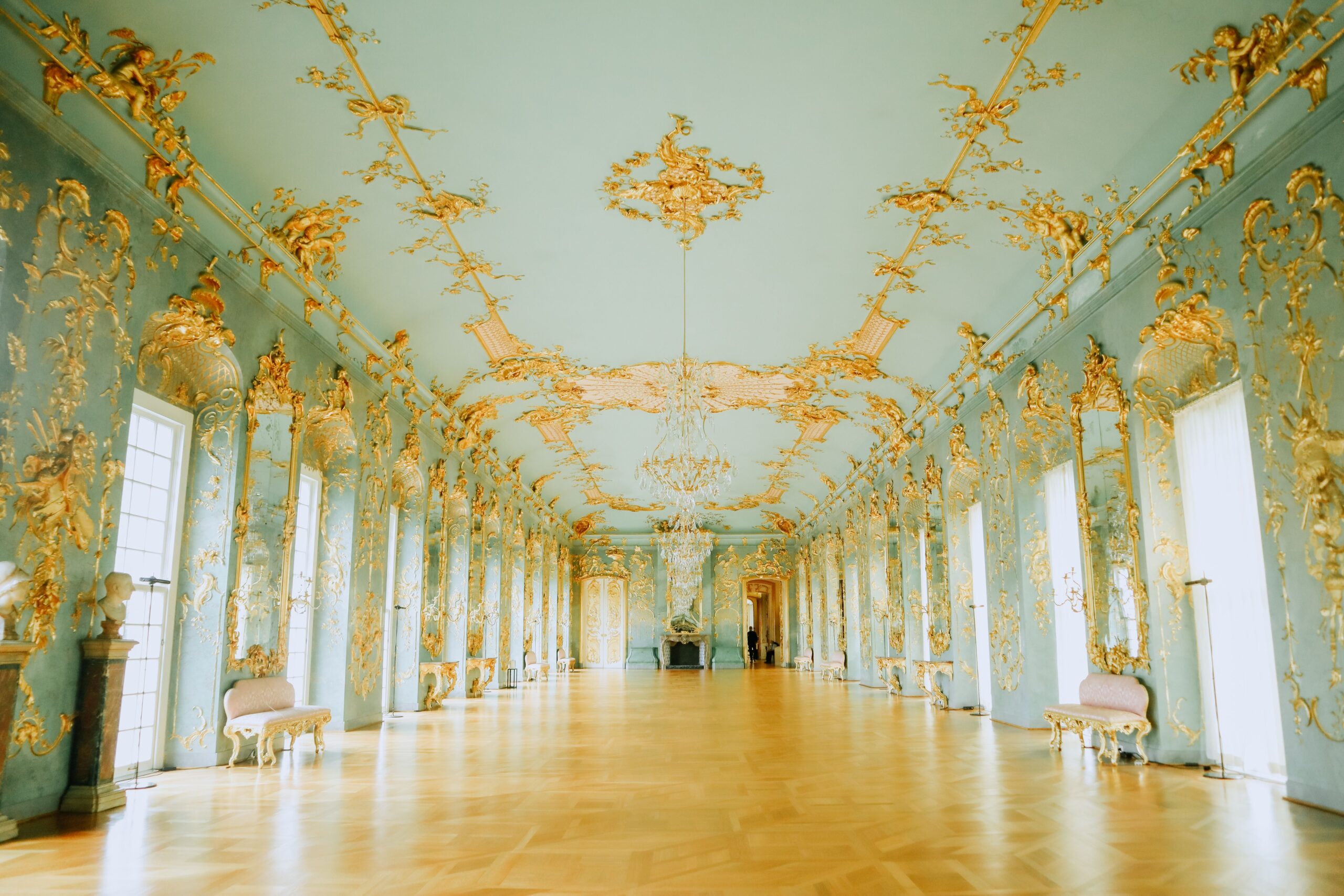 Luxurious and ornate Baroque hall featuring gold embellishments and elegant chandeliers