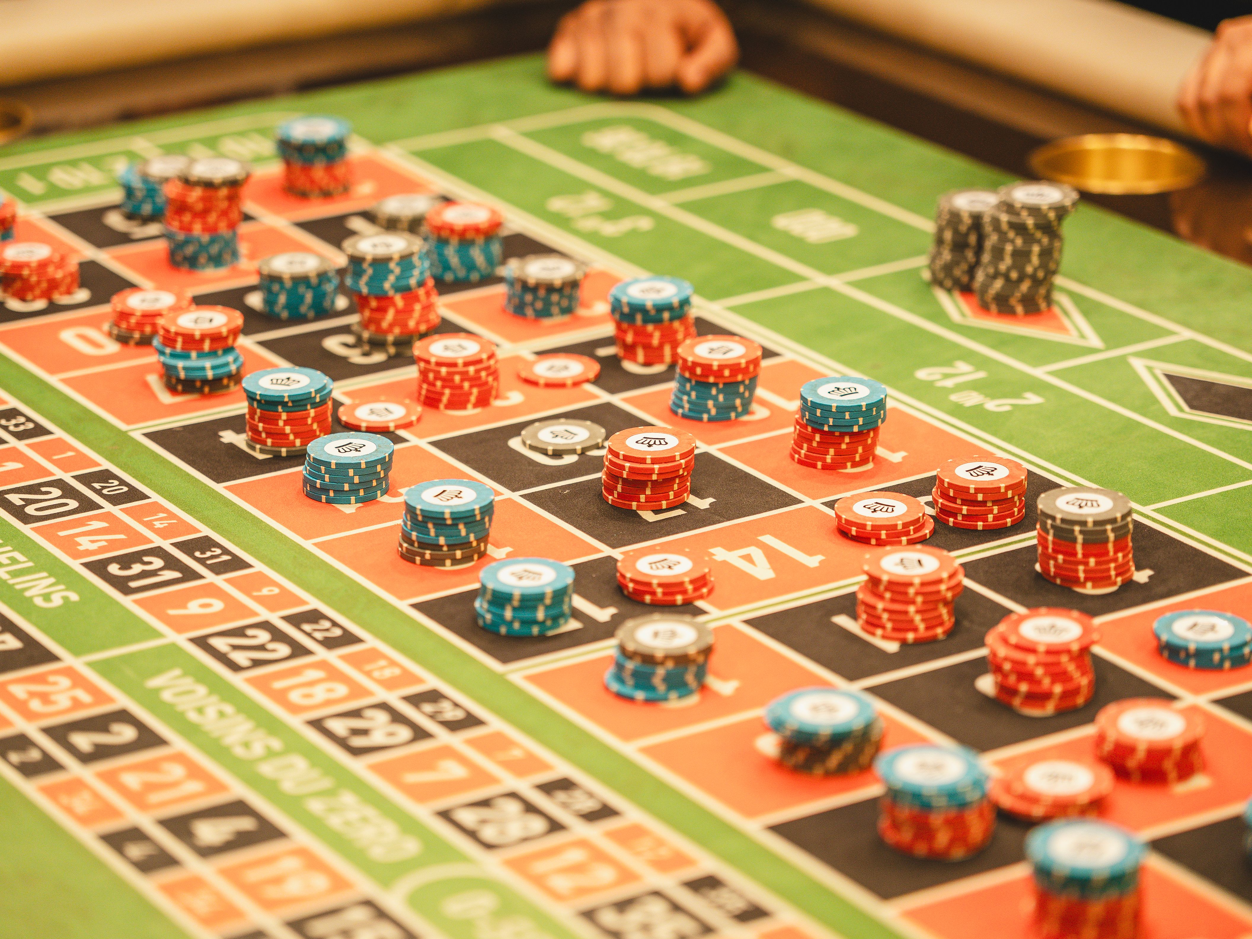 Colorful roulette table with stacks of casino chips in a lively betting atmosphere