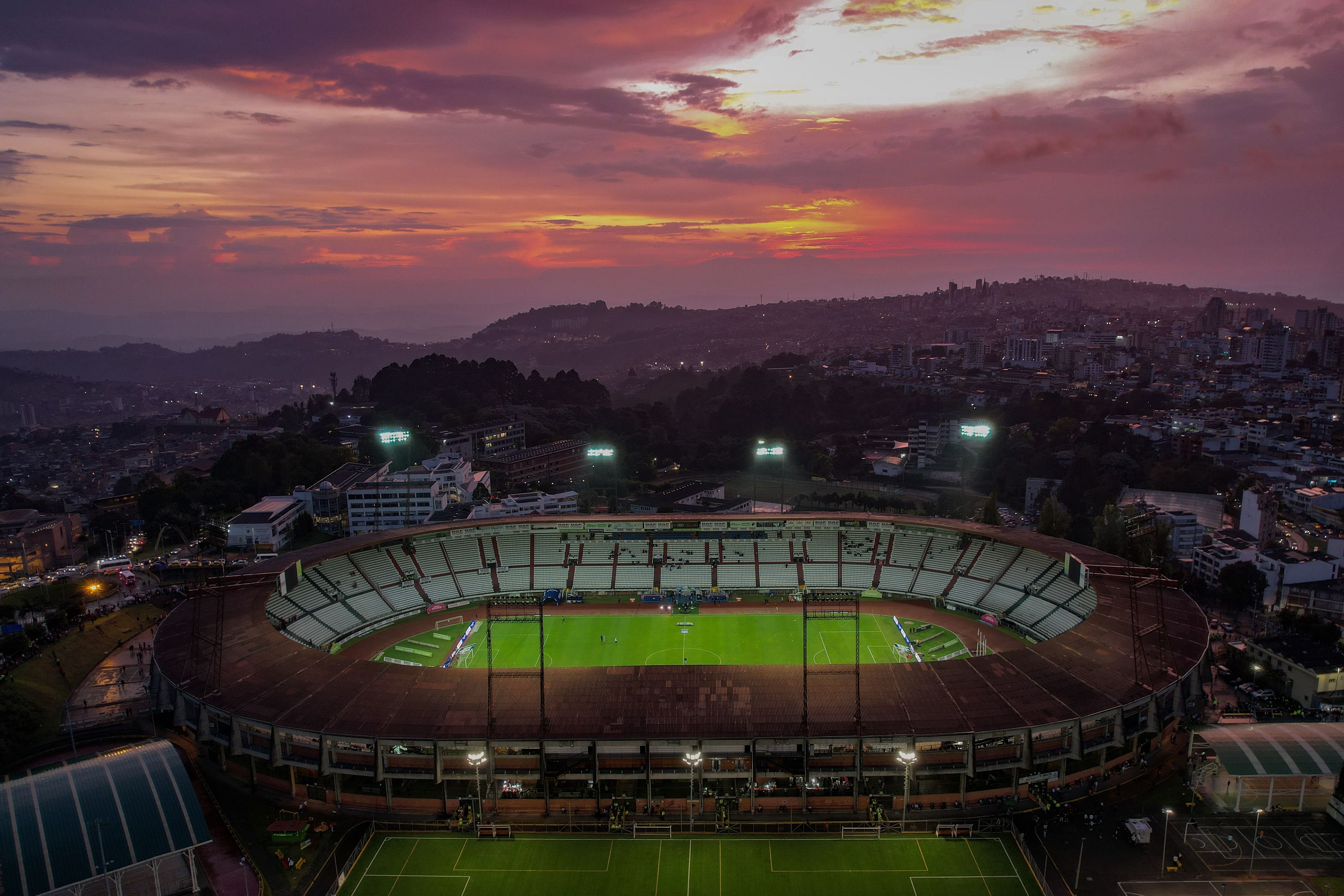 Aerial view of a soccer stadium in Colombia at sunset, reflecting the region's passion for football and sports betting
