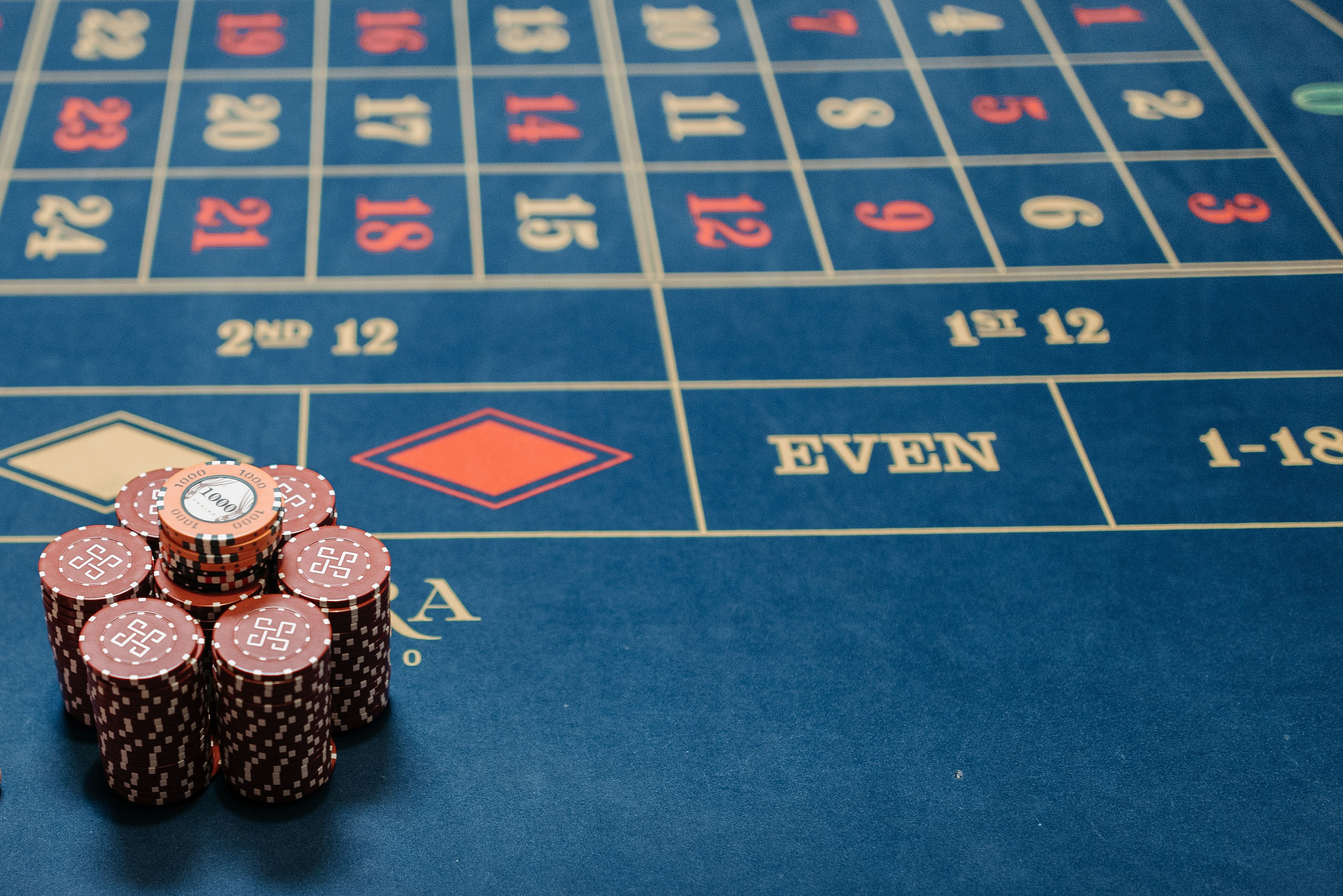 Detailed image of a roulette table with stacked poker chips in a live casino gaming session