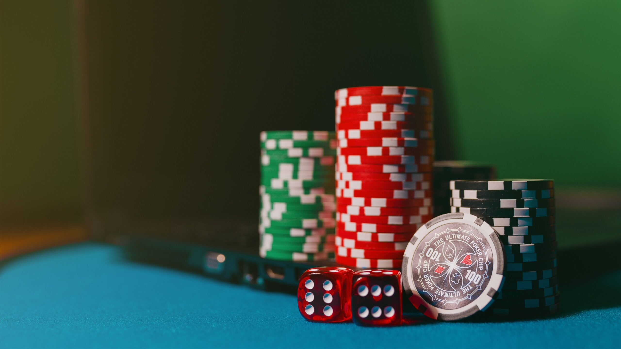 Responsible Gaming: The Practical Tools That Actually Keep Online Betting Fun Casino chips and dice on a felt table beside a laptop, representing online gambling and casino games